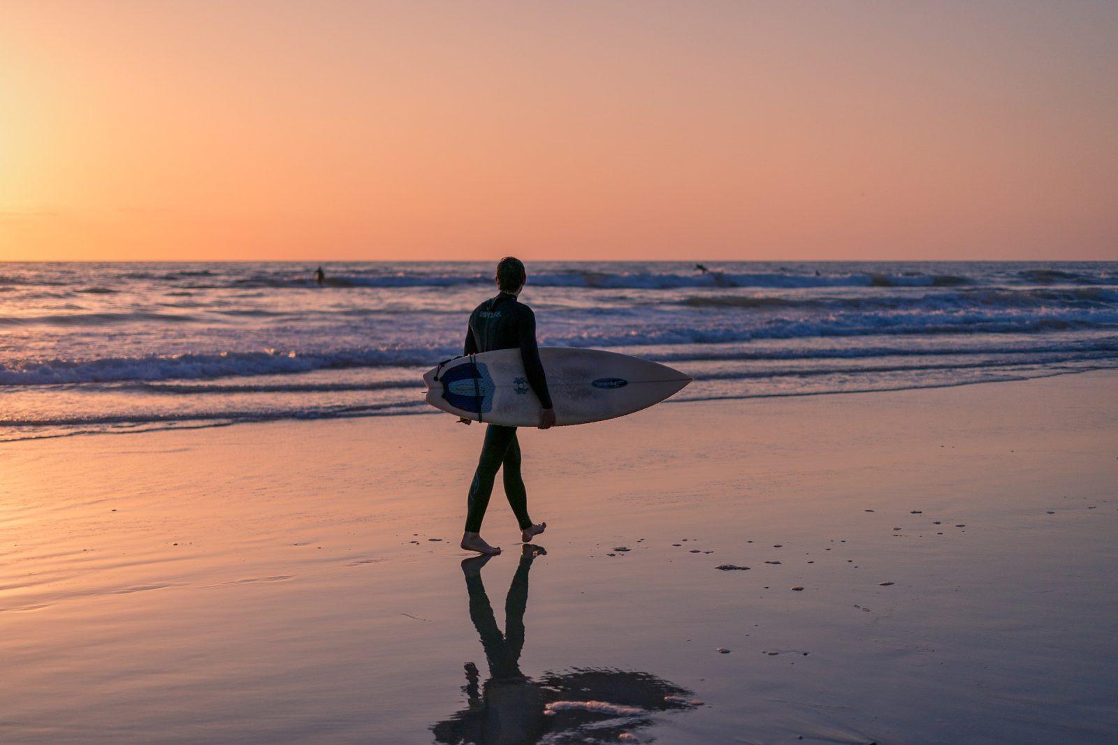 Surfer Walking on San Diego Beach